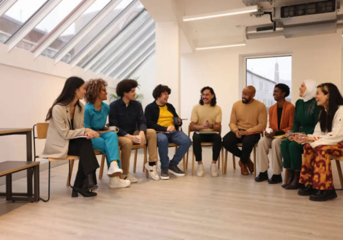 Participants smiling during a social skills group in a residential program