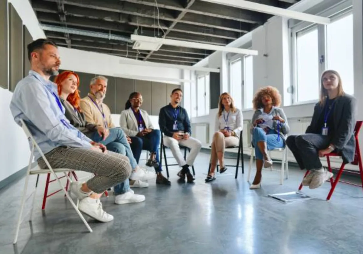 Adults seated in a circle during a group session at a licensed residential program